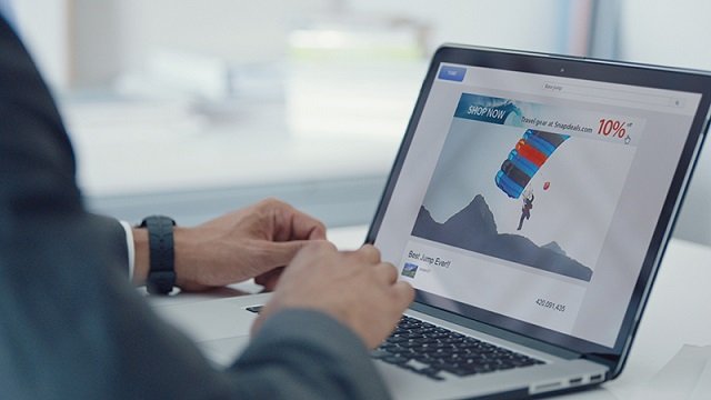 Man using laptop displaying digital advertising. Man using laptop displaying digital advertising.