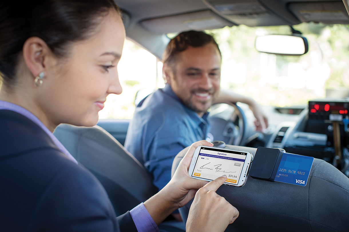 Woman using chip card in taxi to pay. Woman using chip card in taxi to pay.