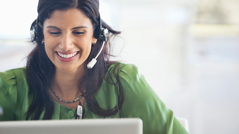 Woman with headset on computer Woman with headset on computer