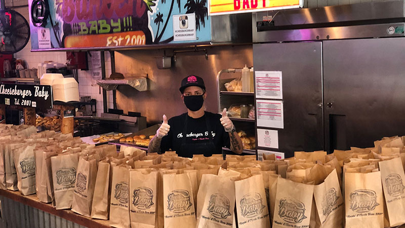 Steph Vitori of Cheeseburger Baby in Miami poses in front of dozens of orders going to hungry customers.
