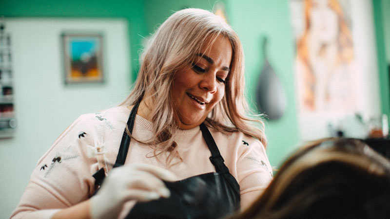 Nancy Gomez, owner of Salon Estilo y Belleza, has been able to keep her business running during challenging times.
