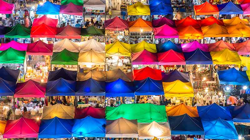 aerial view of night market. multicolor tents with shoppers and merchants