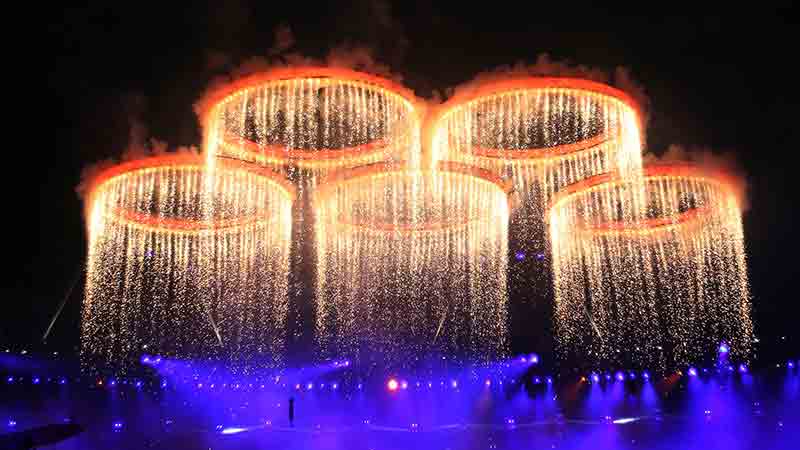 2012 OLYMPIC GAMES - OPENING CEREMONY Olympic rings fireworks against a dark background.
