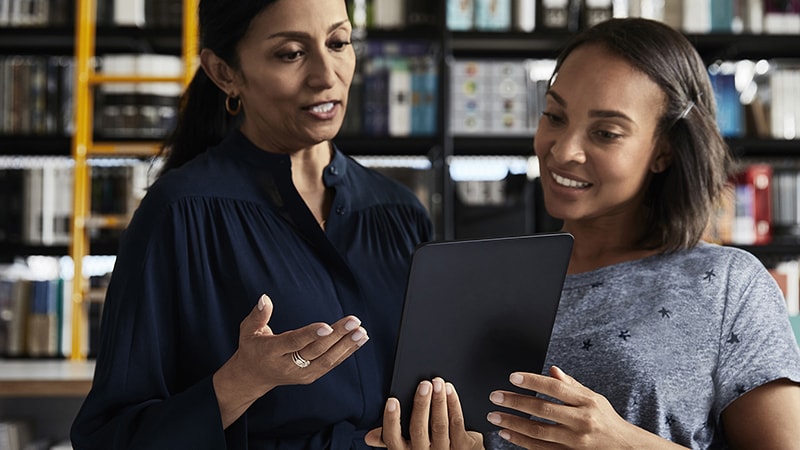 women-coworkers-looking-tablet-800x450