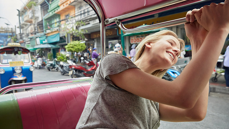 Woman sticking her head out a car window and smiling. Woman sticking her head out a car window and smiling.