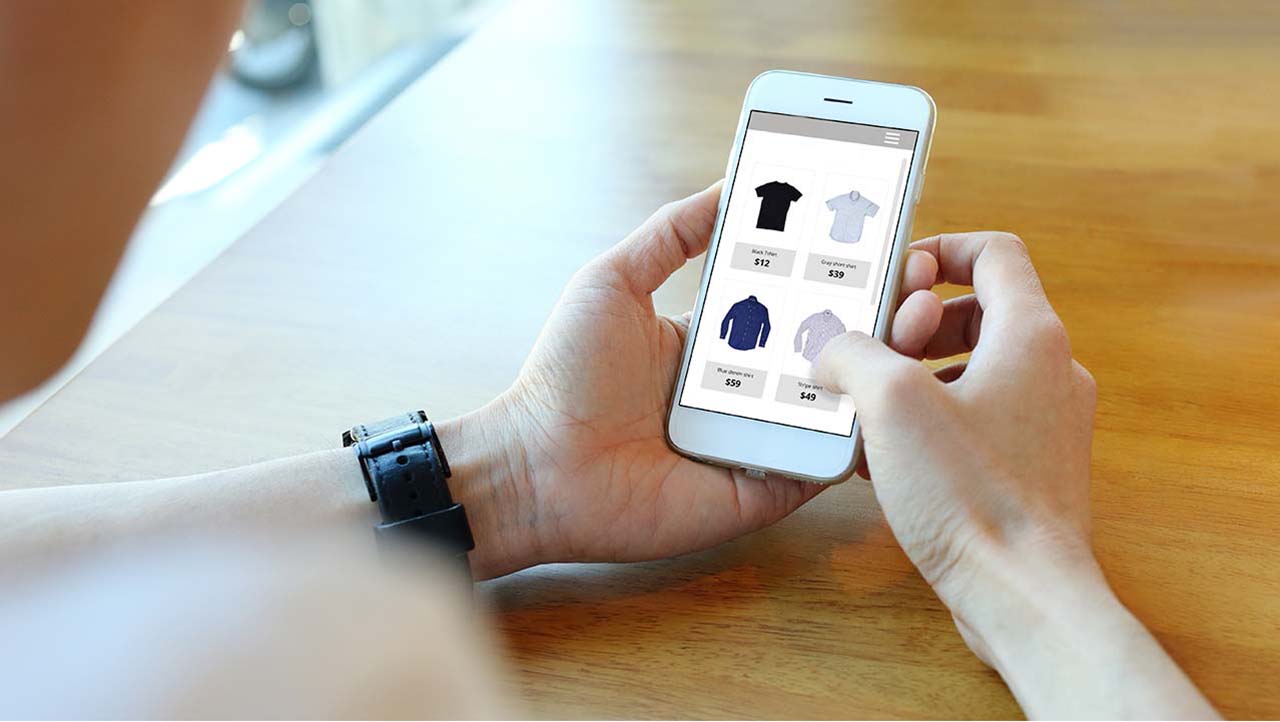 Person using mobile phone to select an item for purchase.