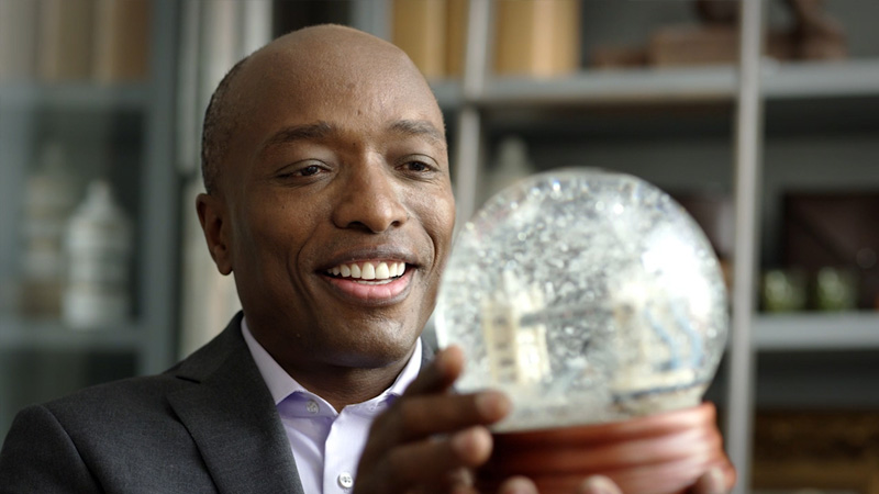 A man admiring a snow globe in his hands. A man admiring a snow globe in his hands.