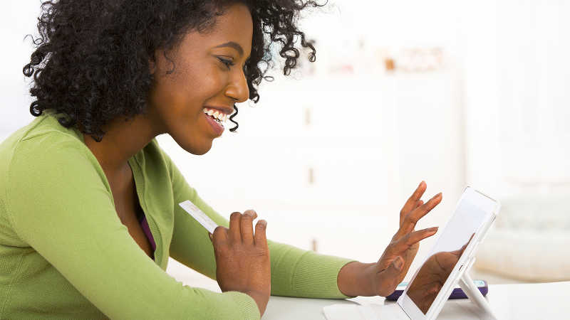 Smiling woman using a tablet. Smiling woman using a tablet.