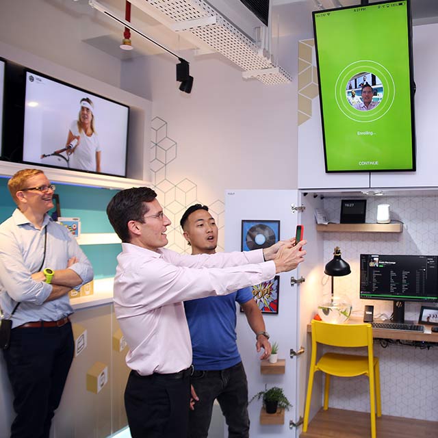 Visa employees at the Dubai Innovation Center test out a new phone app.