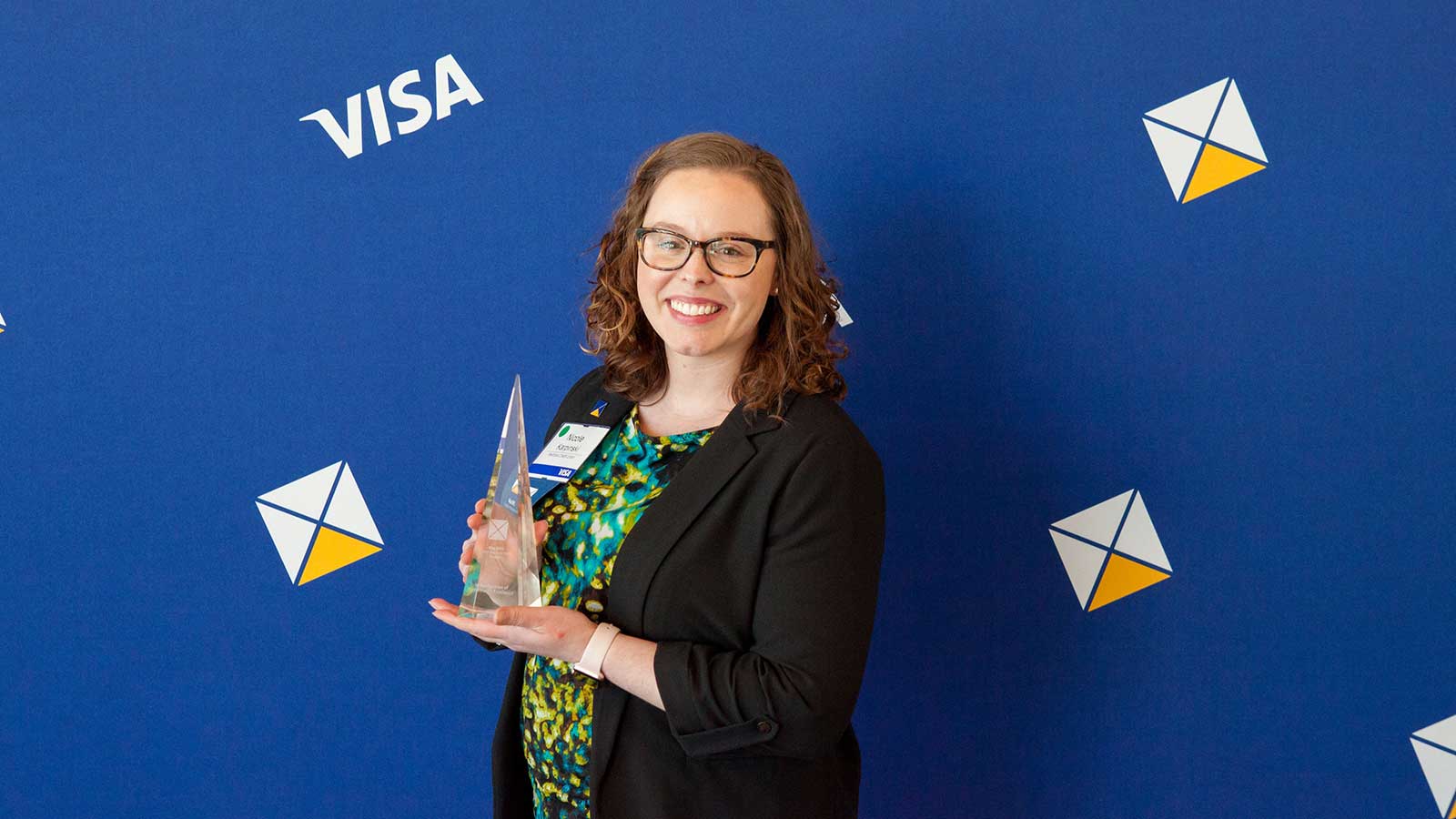 Female award winner holding trophy. 