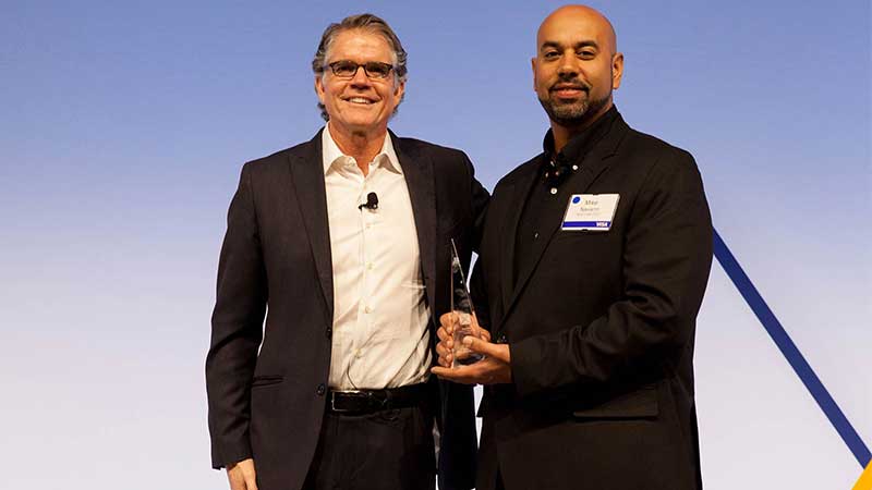 Man standing with male award winner.