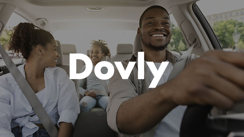 Family riding in car with Dovly logo superimposed.