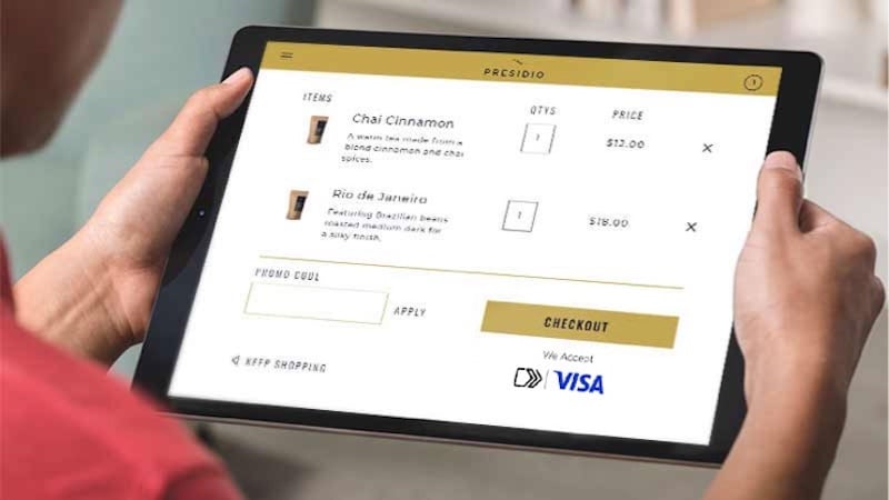 Closeup of a tablet displaying the Visa checkout experience.