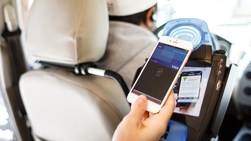 Using a mobile phone in taxi to pay.